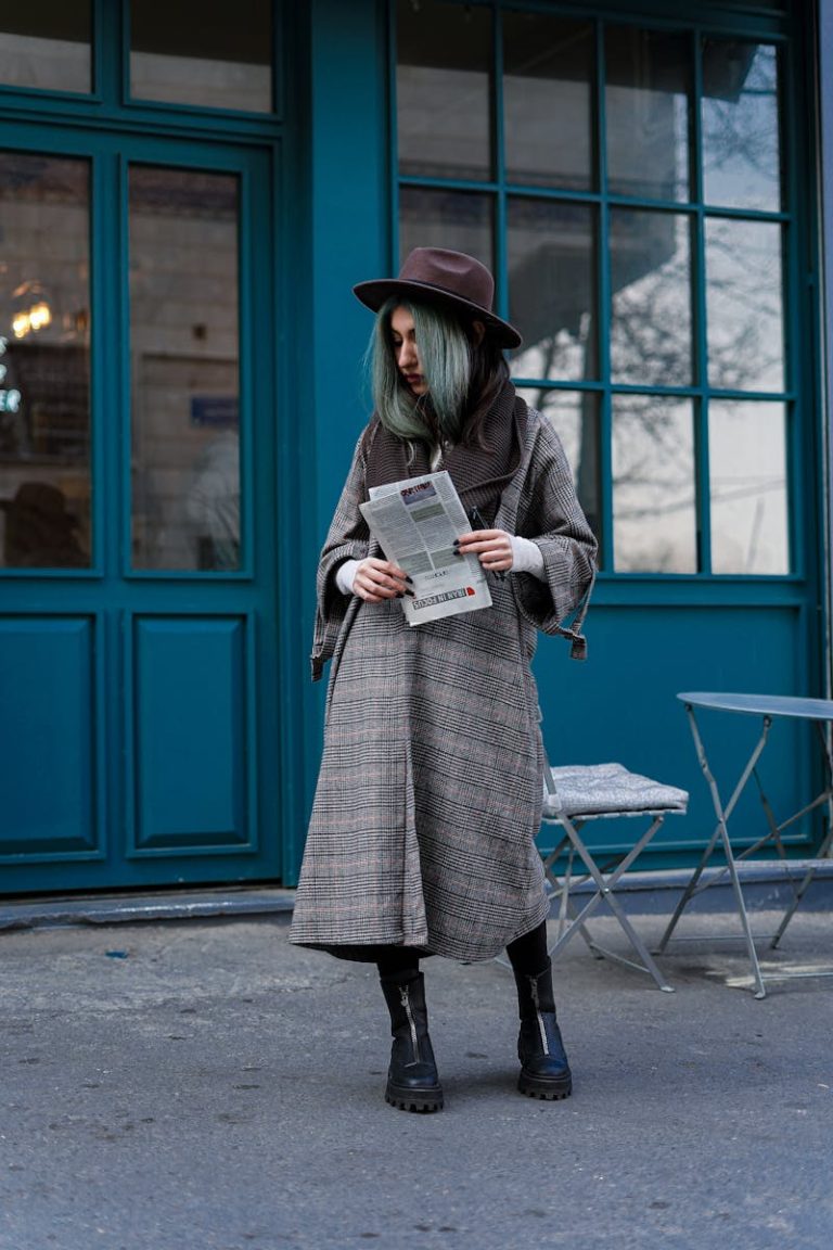 A Woman in Black Coat Holding Newspaper