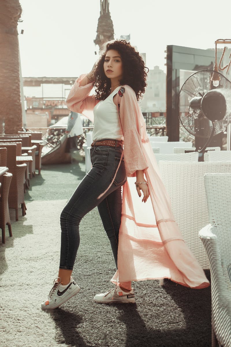 A Woman in White Shirt and Black Denim Jeans Standing on Gray Concrete Floor