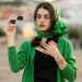 Woman in Green Cardigan Holding a Sunglasses