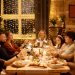 Family celebrating Christmas with dinner and sparklers, creating joyful holiday atmosphere indoors.