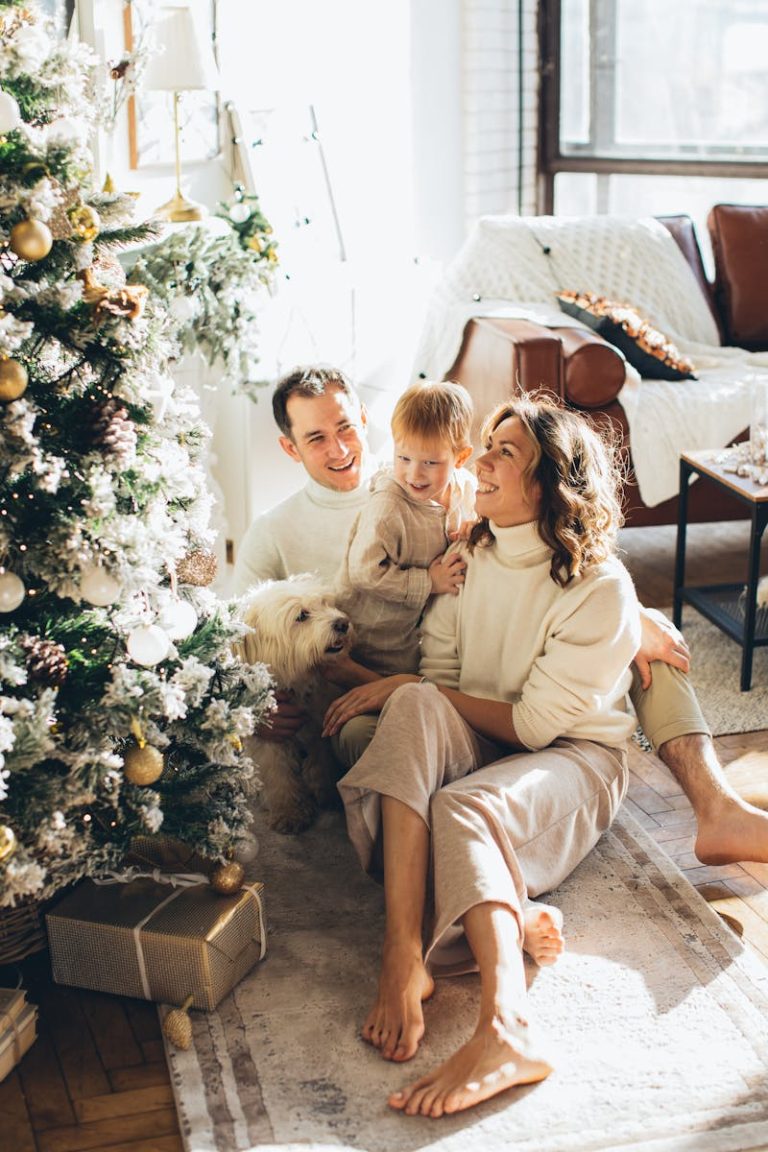 A happy family celebrating Christmas morning with a decorated tree and gifts.